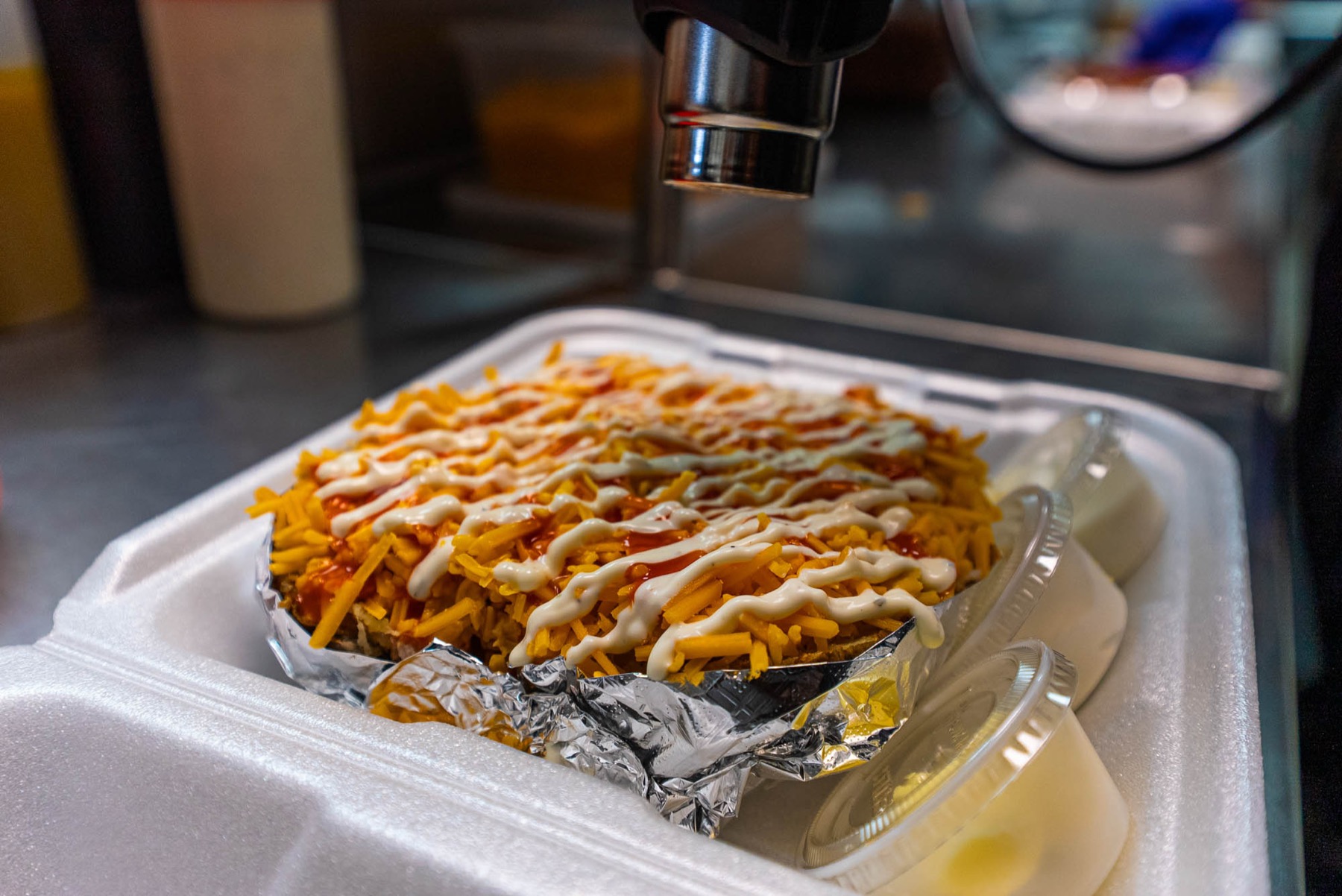 A jumbo baked potato loaded with cheddar, buffalo sauce and ranch