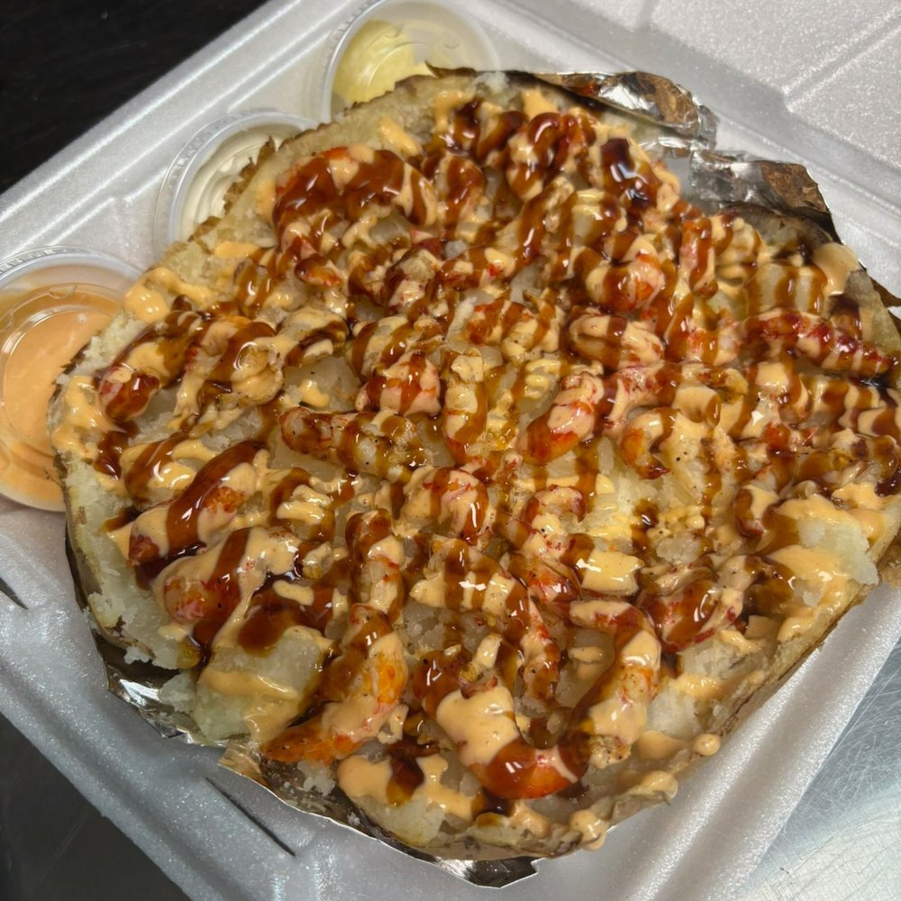 A seafood potato boxed to go, with spicy mayo and eel sauce